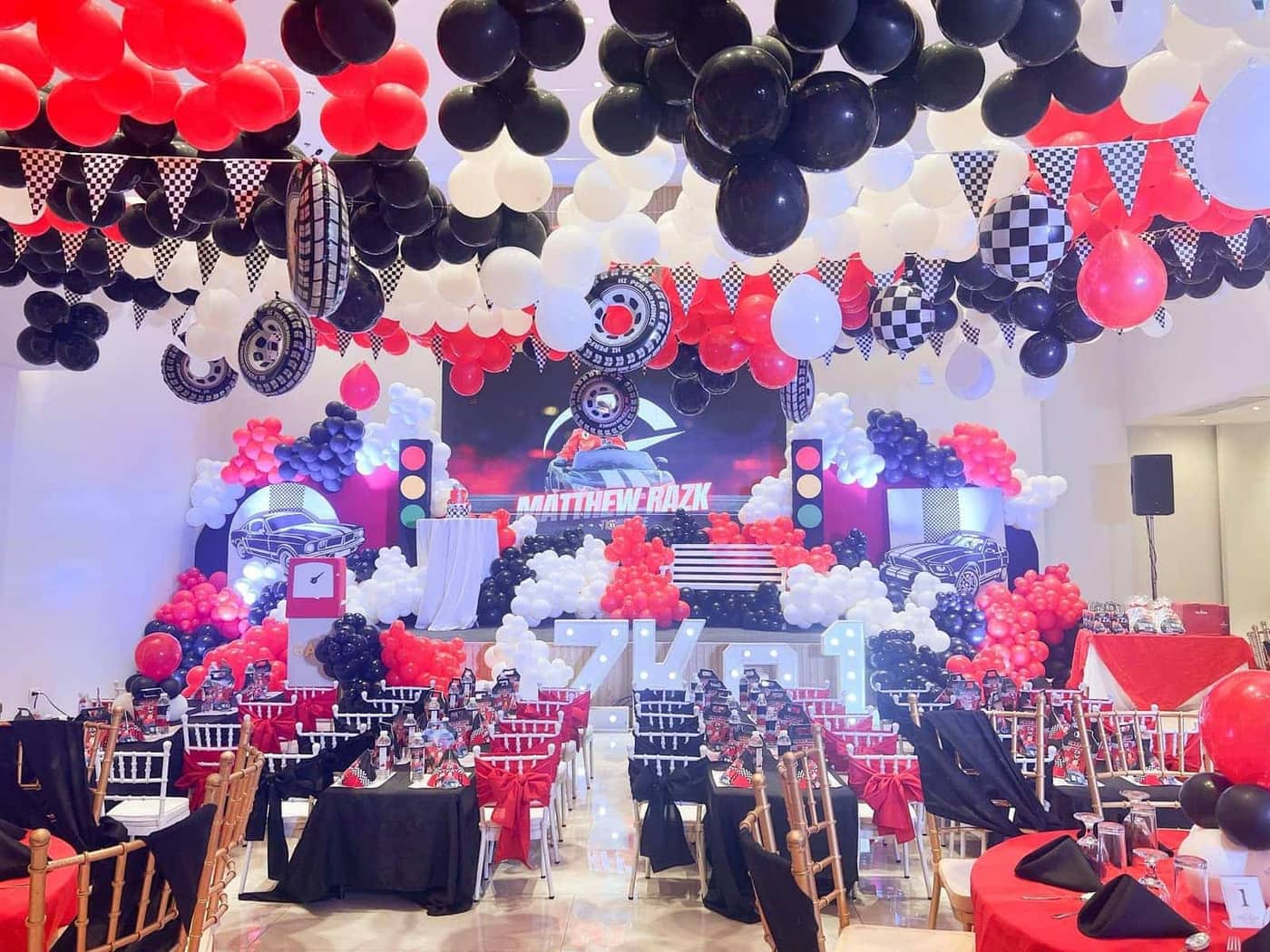 Racing themed birthday with red and black balloon decor